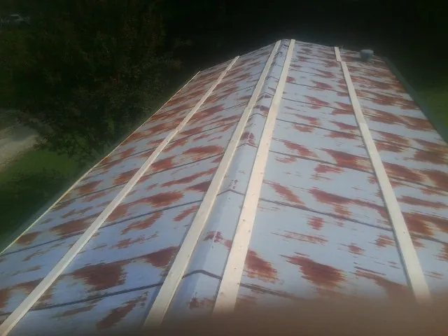 Rusted metal roof panels with new wood purlins before replacement — Storm Damage Roof Repair in Lagunitas by Roofing Brothers