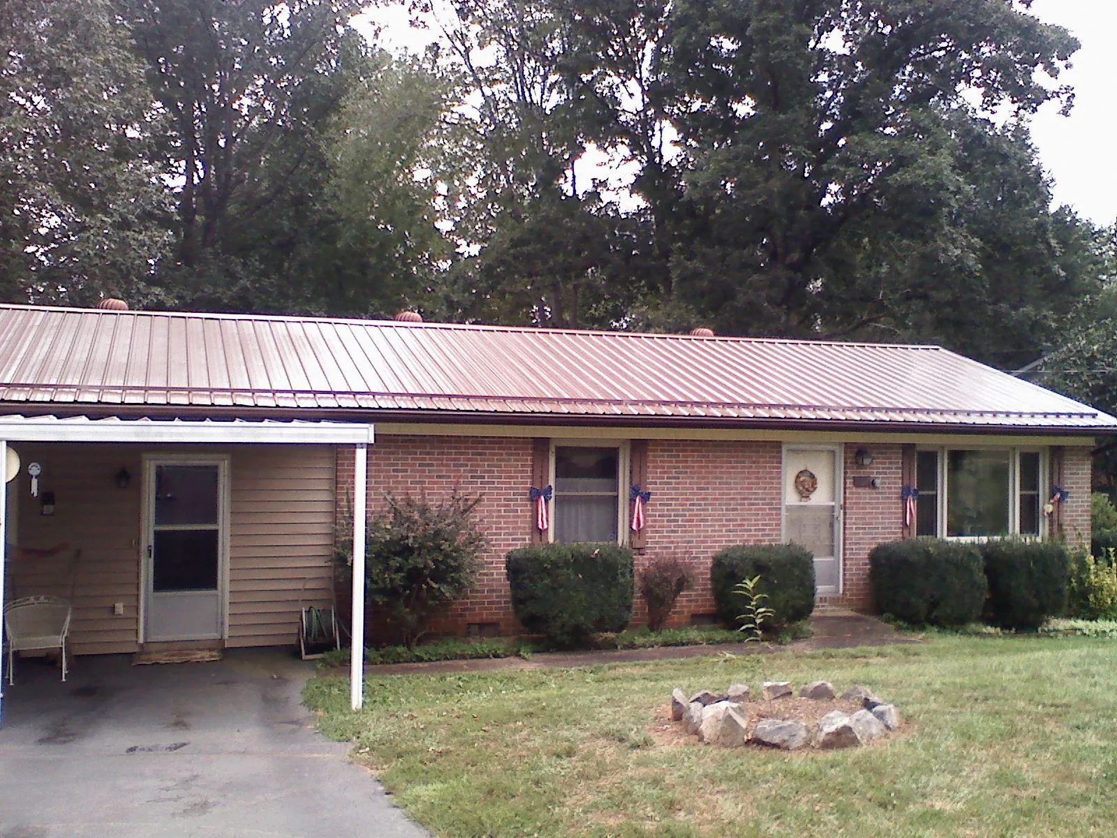 Bronze metal roof and carport on a brick ranch home — Roof Repair work by our crew in Lagunitas